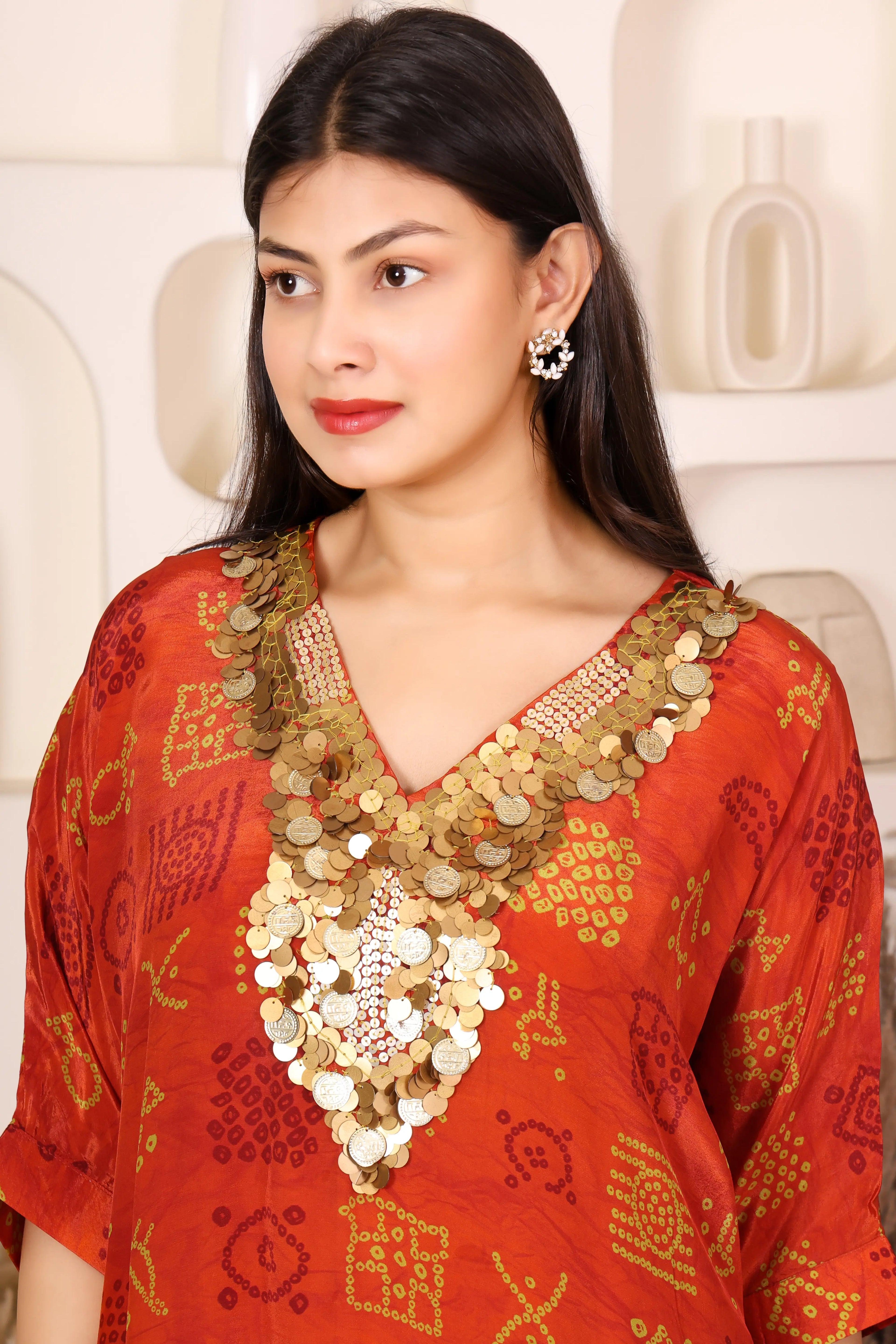 Woman in a red traditional outfit with gold Sequins patterns 