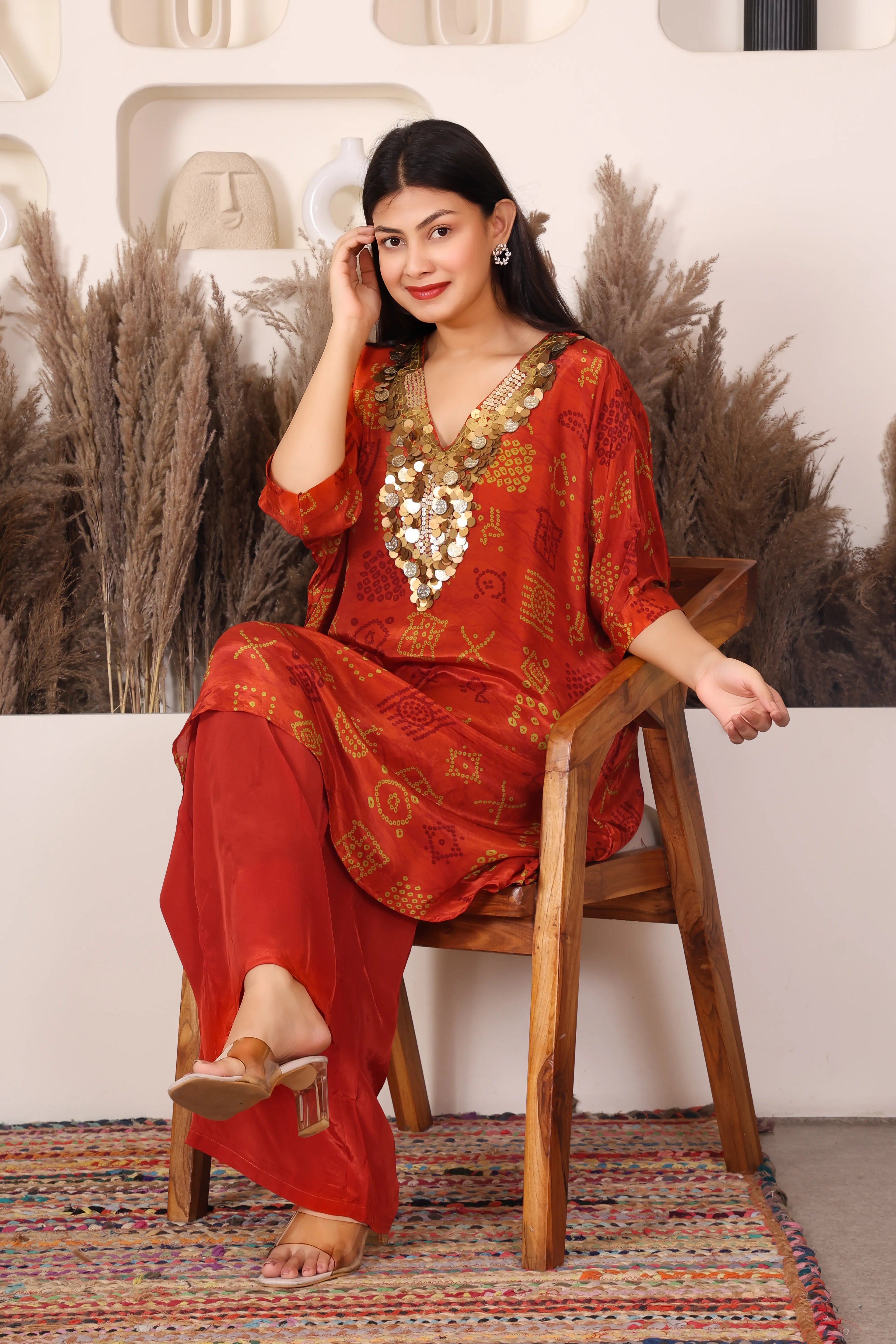 Woman in a red traditional outfit with gold Sequins patterns 