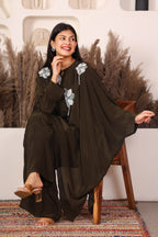 Woman wearing a dark brown traditional outfit with floral embroidery 