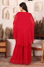 Woman wearing a red outfit with floral embroidery