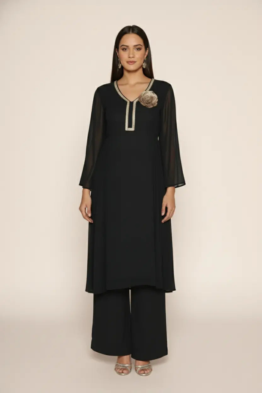 Woman wearing a  black pure georgette kurti set, detailed with shimmering cutdana and stone work. Paired with soft crepe bell-bottom pants and a shantoon lining,