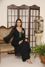 Woman wearing a  black pure georgette kurti set, detailed with shimmering cutdana and stone work. Paired with soft crepe bell-bottom pants and a shantoon lining,