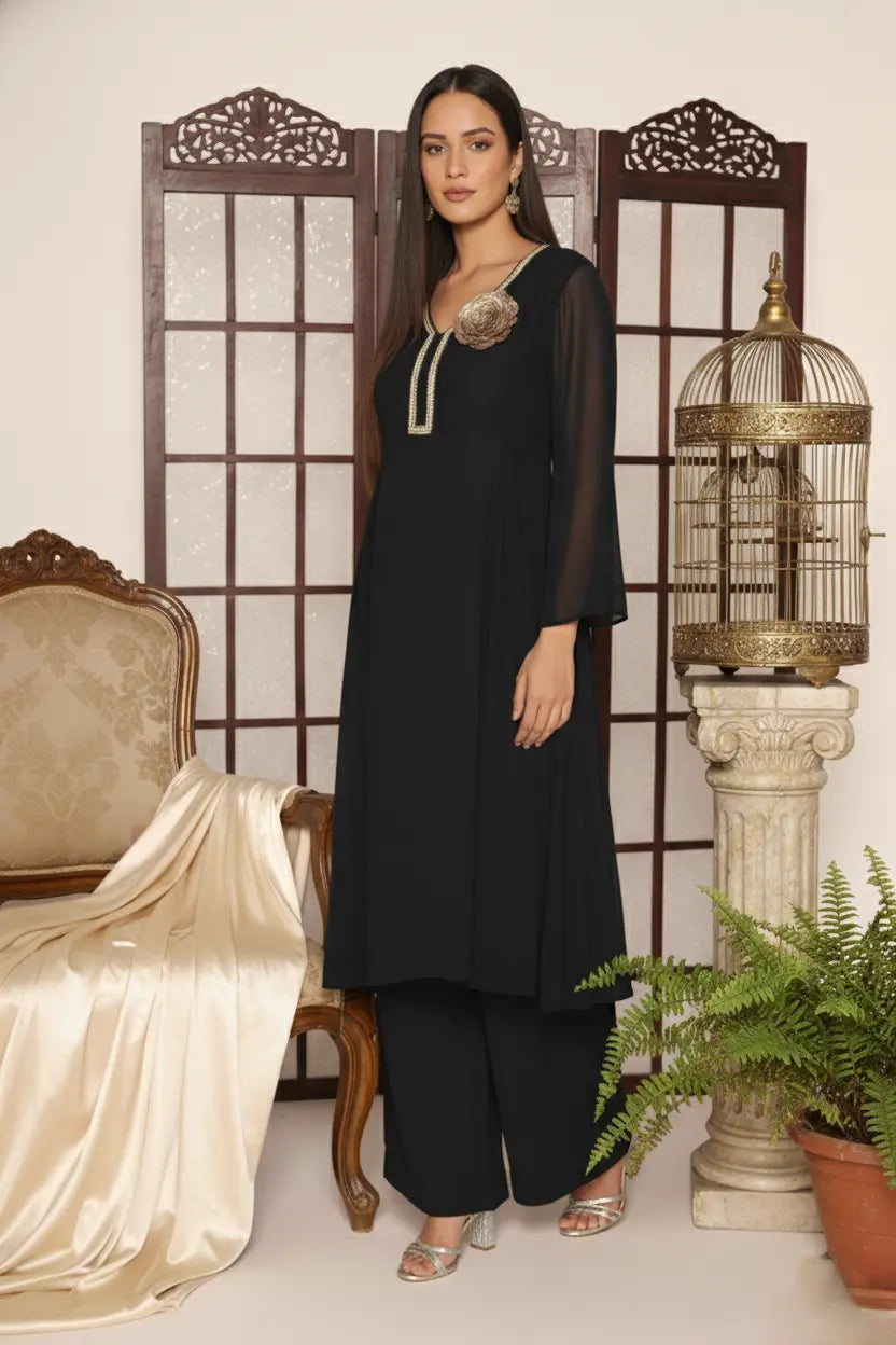 Woman wearing a  black pure georgette kurti set, detailed with shimmering cutdana and stone work. Paired with soft crepe bell-bottom pants and a shantoon lining,
