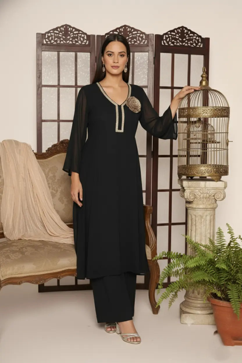 Woman wearing a  black pure georgette kurti set, detailed with shimmering cutdana and stone work. Paired with soft crepe bell-bottom pants and a shantoon lining,