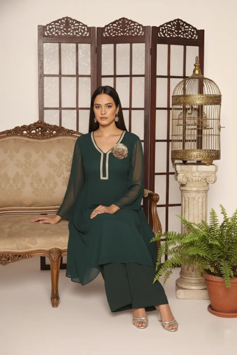 Elegant bottle green georgette kurti set with side pleats, sequin-detailed neckline, floral embellishment, shantoon lining, and crepe bell-bottom pants.