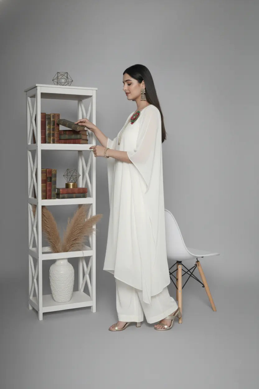 Woman wearing ivory Reagan-style kaftan co-ord set, crafted in pure georgette with vibrant thread floral applique and delicate cutdana accents. Paired with crepe bell-bottom pants and soft shantoon lining for a luxurious festive look.