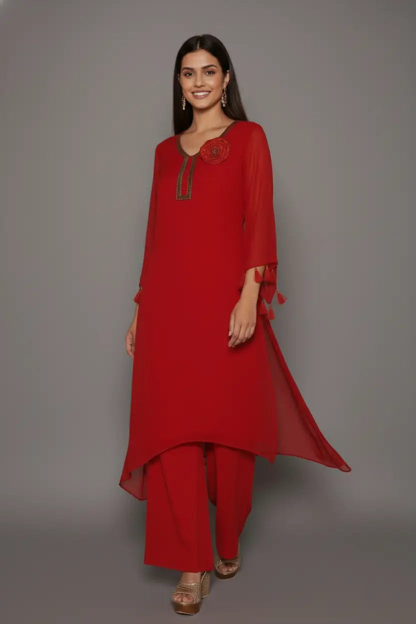 Woman wearing A Bold and elegant crimson georgette kurti set with thread and cutdana work, tassel-detailed sleeves, soft shantoon lining, and stylish crepe bell-bottom pants.