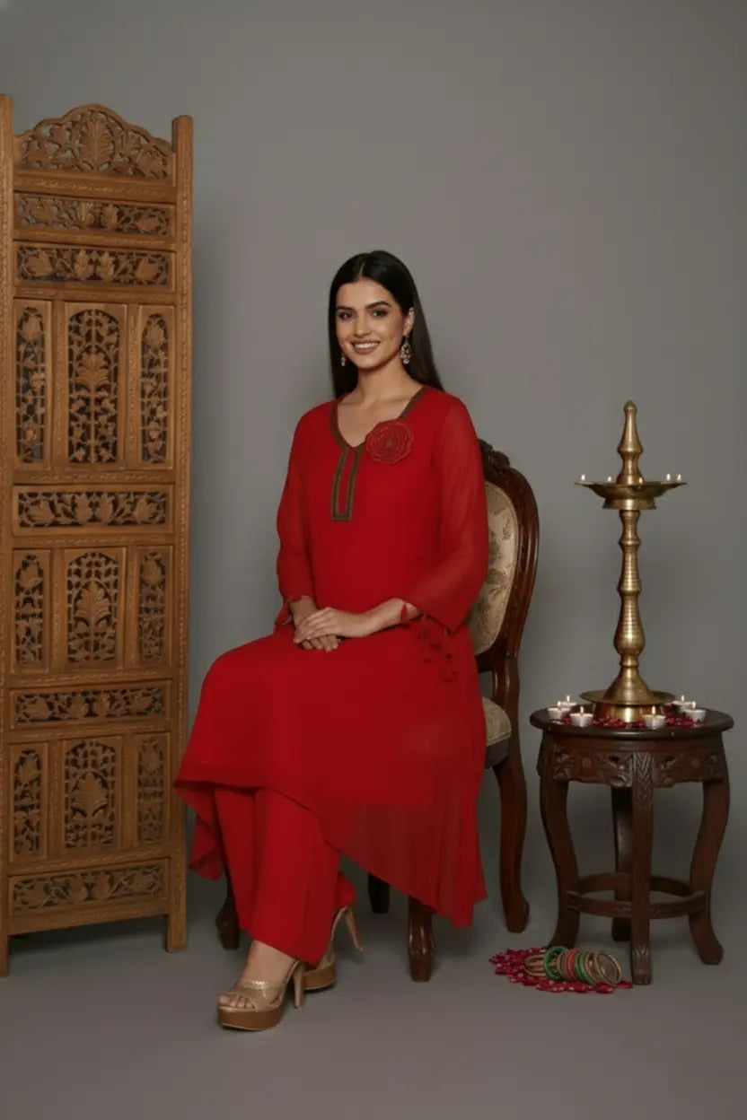 Woman wearing A Bold and elegant crimson georgette kurti set with thread and cutdana work, tassel-detailed sleeves, soft shantoon lining, and stylish crepe bell-bottom pants.